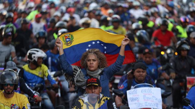Motorcyclists supporting Venezuelan President Nicolas Maduro take part in a motorcade to protest against the United States in Caracas on December 22, 2025. Dressed as pirates, dozens of motorcyclists rode through Caracas on December 22 to protest the seizure of ships carrying Venezuelan oil by the United States as part of its blockade against sanctioned tankers. (Photo by Pedro MATTEY / AFP)