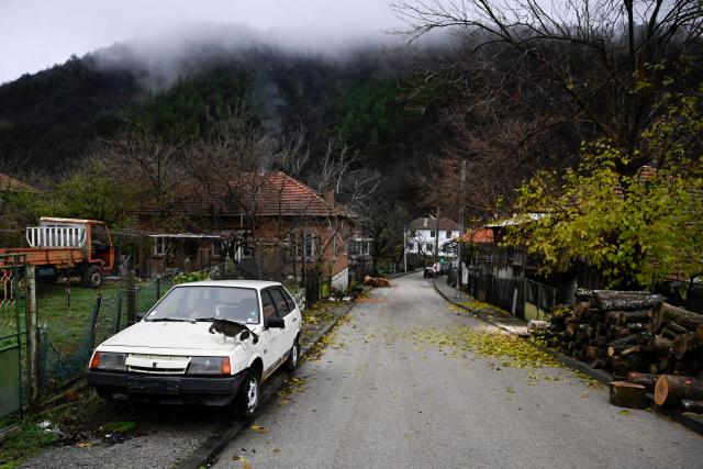 A cat jumps from a car in the village of Chuprene, northwestern Bulgaria on December 7, 2025. Bulgaria shaken by political uncertainty, with the latest short-lived government resigning last week -- becomes the single currency area's 21st member on January 1, nearly 19 years after the country of 6.4 million people joined the European Union. (Photo by Nikolay DOYCHINOV / AFP)