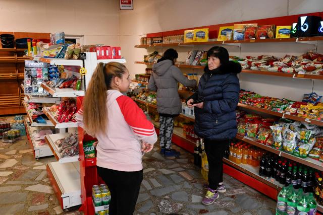 Customers shop in a grocery store in the village of Chuprene, northwestern Bulgaria on December 7, 2025. Bulgaria shaken by political uncertainty, with the latest short-lived government resigning last week -- becomes the single currency area's 21st member on January 1, nearly 19 years after the country of 6.4 million people joined the European Union. (Photo by Nikolay DOYCHINOV / AFP)