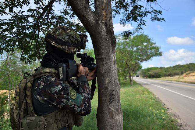 (FILES) A Colombian soldier is seen during an operation to deactivate gas cylinders allegedly loaded with explosives by the ELN on a road near Cucuta, department of Norte de Santander, Colombia, on December 15, 2025. The 18 soldiers who had been held by a local community in an ELN guerrilla enclave in Choco department, Colombia, were released on the night of December 22, 2025, the Ombudsman's Office announced. The troops were conducting an operation against the ELN guerrilla group, Defense Minister Pedro Sanchez said on December 21. (Photo by SCHNEYDER MENDOZA / AFP)