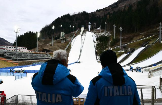 A photograph taken on December 22, 2025 shows the Ski Jumping arena prior the Open Italian Championship of ski jumping in Predazzo. The Ski Jumping arena in Predazzo will host the ski jumping and nordic combined competitions, during the Milano Cortina 2026 Winter Olympic Games. (Photo by Stefano RELLANDINI / AFP)