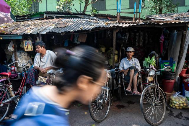 Trishaw drivers wait for customers in Yangon on December 23, 2025. (Photo by Sai Aung MAIN / AFP)