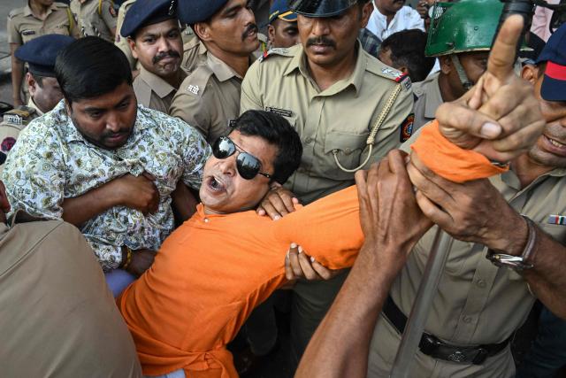 Police detain Vishva Hindu Parishad (VHP) activists during a protest near the Bangladesh Deputy High Commission in Mumbai in Mumbai on December 23, 2025 held to condemn the killing of Hindu garment worker Dipu Chandra Das. On December 18, angry mobs in the majority Muslim nation of Bangladesh's capital of Dhaka attacked the offices of Prothom Alo and the Daily Star, torching parts of the buildings and vandalising the premises of the two publications caught up in surging anti-India sentiment in the wake of popular student leader Sharif Osman Hadi's death. The violence also saw Hindu garment worker Das killed following allegations of blasphemy. (Photo by Indranil MUKHERJEE / AFP)