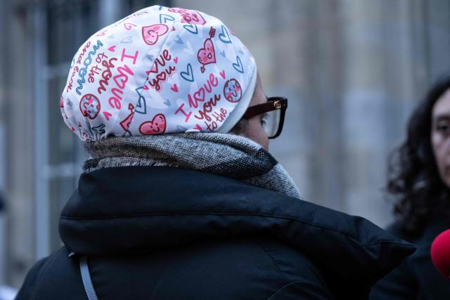 Nurse Majdouline dismissed from the civil service for wearing a skullcap speaks to journalists in front of the administrative court in Paris on December 23, 2025. (Photo by BERTRAND GUAY / AFP)