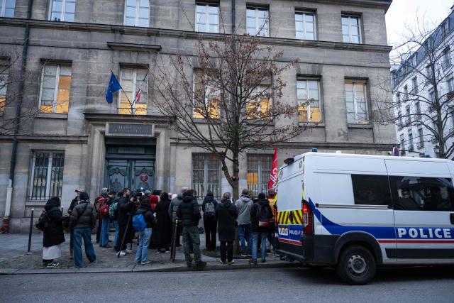 People arrive to show support to nurse Majdouline who was dismissed from the civil service for wearing a skullcap speaks to journalists in front of the administrative court in Paris on December 23, 2025. (Photo by BERTRAND GUAY / AFP)