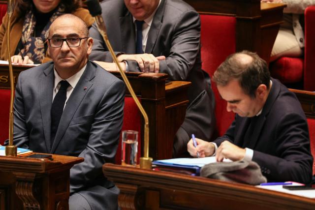 France's Interior Minister Laurent Nunez (L) looks on next to France's Prime Minister Sebastien Lecornu during a session of questions to the government at The National Assembly, France's lower house parliament, in Paris on December 23, 2025. (Photo by Thomas SAMSON / AFP)