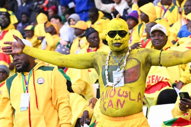 A Gabon's supporter cheers during the Africa Cup of Nations (CAN) Group D football match between Democratic Republic of Congo and Benin at Al Medina Stadium in Rabat on December 23, 2025. (Photo by SEBASTIEN BOZON / AFP)