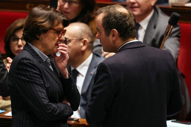 France's Prime Minister Sebastien Lecornu (R) speaks with France's Agriculture Minister Annie Genevard during a session of questions to the government at The National Assembly, France's lower house parliament, in Paris on December 23, 2025. (Photo by Thomas SAMSON / AFP)