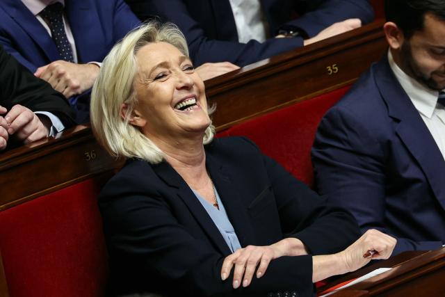 President of Rassemblement National parliamentary group Marine Le Pen laughs during a session of questions to the government at The National Assembly, France's lower house parliament, in Paris on December 23, 2025. (Photo by Thomas SAMSON / AFP)