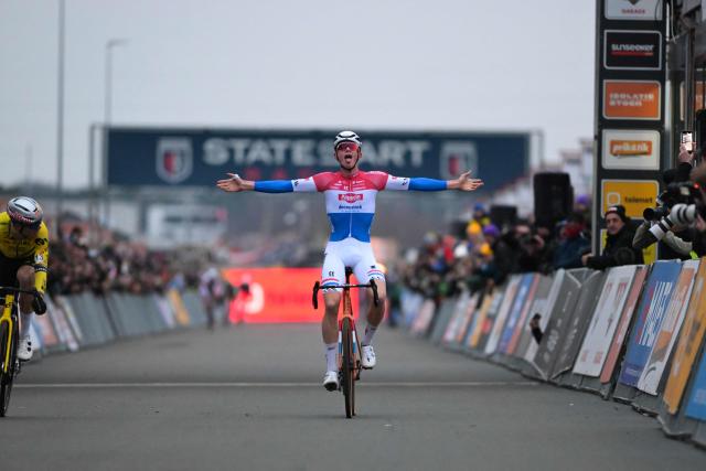 Dutch rider Tibor Del Grosso (c) celebrates as he crosses the finish line to win the men's elite race at the cyclo-cross cycling event, stage 5 out of 8 of the Superprestige competition, in Heusden-Zolder on December 23, 2025. (Photo by DAVID PINTENS / Belga / AFP) / Belgium OUT