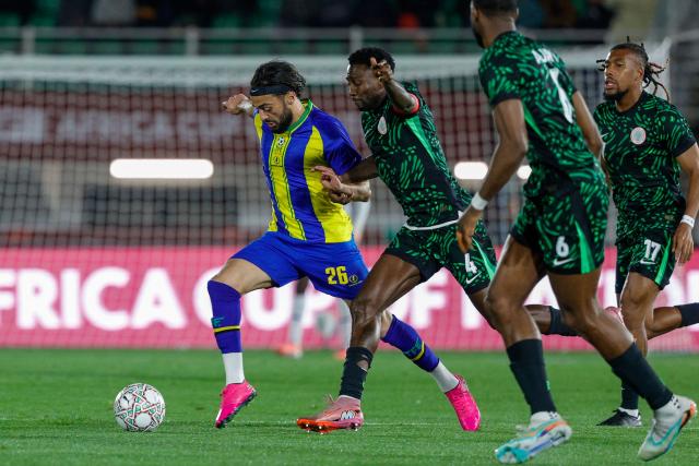 Tanzania's midfielder #26 Tarryn Allarakhia outpasses Nigeria's midfielder #04 Wilfred Ndidi and Nigeria's forward #17 Alex Iwobi during the Africa Cup of Nations (CAN) Group C football match between Nigeria and Tanzania at Fez Stadium in Fes on December 23, 2025. (Photo by Abdel Majid BZIOUAT / AFP)