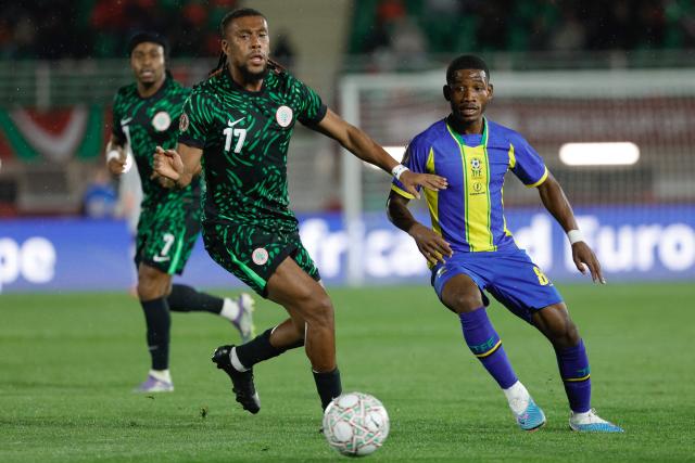 Nigeria's forward #17 Alex Iwobi and Tanzania's midfielder #08 Charles M'Mombwa vie during the Africa Cup of Nations (CAN) Group C football match between Nigeria and Tanzania at Fez Stadium in Fes on December 23, 2025. (Photo by Abdel Majid BZIOUAT / AFP)