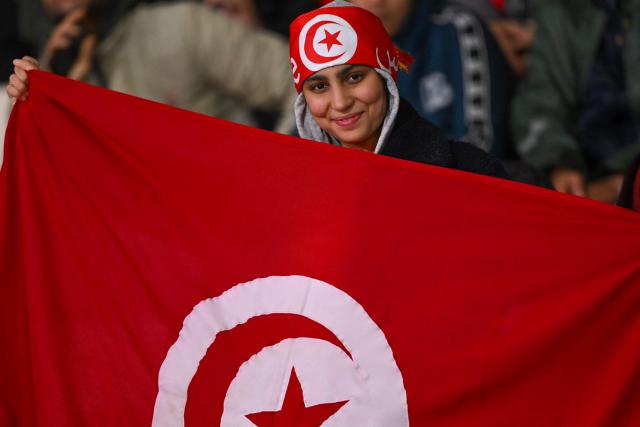 A Tunisia supporter cheers ahead of the Africa Cup of Nations (CAN) Group C football match between Tunisia and Uganda at Rabat Olympic Stadium in Rabat on December 23, 2025. (Photo by SEBASTIEN BOZON / AFP)