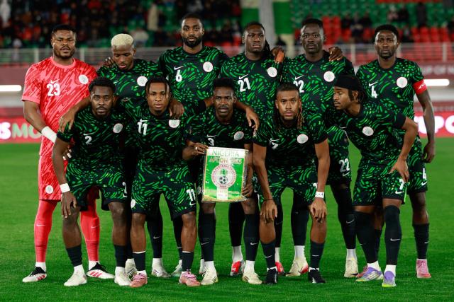 (From L) Nigeria's goalkeeper #23 Stanley Nwabali, Nigeria's defender #02 Bright Osayi-Samuel, Nigeria's forward #09 Victor Osimhen, Nigeria's forward #11 Samuel Chukwueze, Nigeria's defender #06 Semi Ajayi, FC Porto's Nigerian defender #12 Zaidu Sanusi, Nigeria's defender #21 Calvin Bassey, Nigeria's forward #17 Alex Iwobi, Nigeria's forward #22 Akor Adams, and Nigeria's midfielder #04 Wilfred Ndidi pose prior the Africa Cup of Nations (CAN) Group C football match between Nigeria and Tanzania at Fez Stadium in Fes on December 23, 2025. (Photo by Abdel Majid BZIOUAT / AFP)