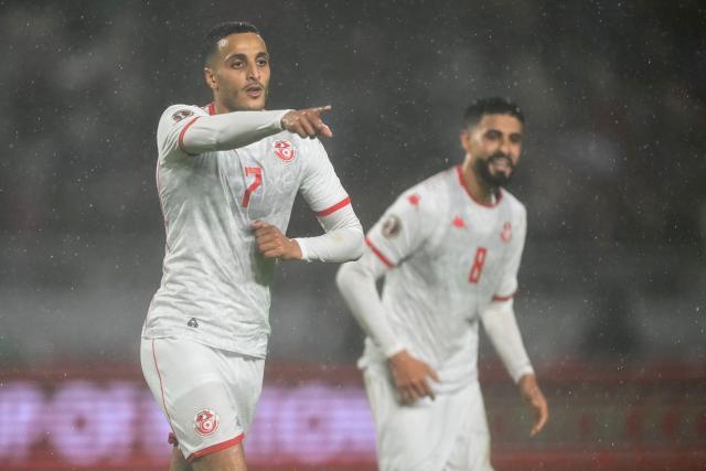 Tunisia's forward #07 Elias Achouri and Tunisia's forward #08 Elias Saad celebrate a goal during the Africa Cup of Nations (CAN) Group C football match between Tunisia and Uganda at Rabat Olympic Stadium in Rabat on December 23, 2025. (Photo by Paul ELLIS / AFP)