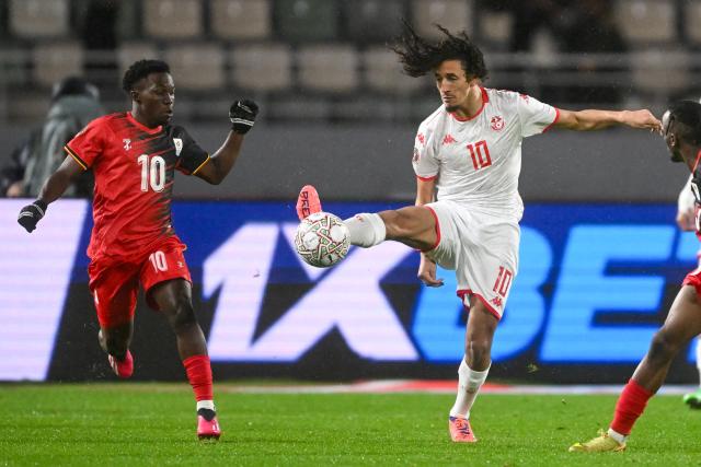 Uganda's midfielder #10 Travis Mutyaba and Tunisia's midfielder #10 Hannibal vie during the Africa Cup of Nations (CAN) Group C football match between Tunisia and Uganda at Rabat Olympic Stadium in Rabat on December 23, 2025. (Photo by SEBASTIEN BOZON / AFP)