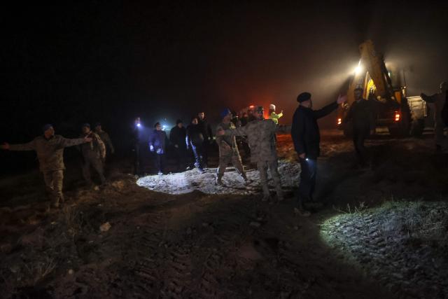 TOPSHOT - Turkish soldiers evacuate journalists and bystanders from the wreckage site as search and rescue operations are ungoing following the crash of a Libya-bound business jet carrying Libyan Chief of Staff General Muhammad Ali Ahmed Al-Haddad, found 2 kilometers south of Kesikkavak Village at Haymana district in Ankara on December 23, 2025. The head of Libya's armed forces and four other passengers died on December 23, 2025, when their business jet crashed shortly after taking off from Ankara, officials in Turkey's capital and Tripoli said. The wreckage of their Falcon 50 aircraft was located by Turkish security personnel in the Haymana district near Ankara, Turkey's Interior Minister said. (Photo by ADEM ALTAN / AFP)