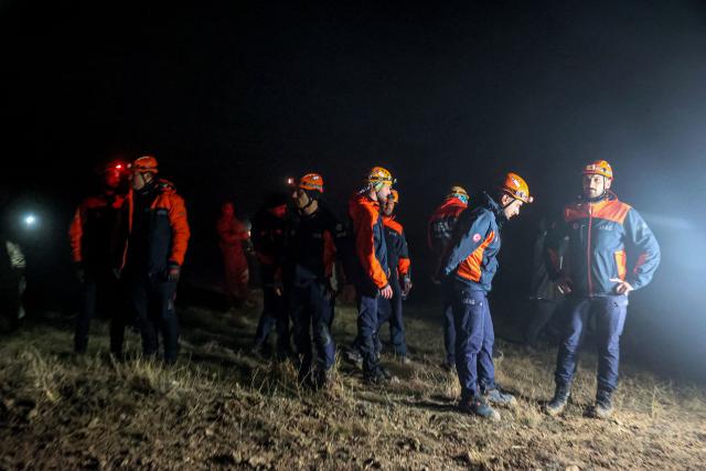 Rescuers work as search and rescue operations are ungoing at the wreckage site following the crash of a Libya-bound business jet carrying Libyan Chief of Staff General Muhammad Ali Ahmed Al-Haddad, found 2 kilometers south of Kesikkavak Village at Haymana district in Ankara on December 23, 2025. The head of Libya's armed forces and four other passengers died on December 23, 2025, when their business jet crashed shortly after taking off from Ankara, officials in Turkey's capital and Tripoli said. The wreckage of their Falcon 50 aircraft was located by Turkish security personnel in the Haymana district near Ankara, Turkey's Interior Minister said. (Photo by ADEM ALTAN / AFP)