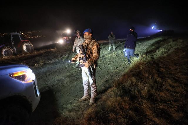 TOPSHOT - Turkish soldiers stand guard at the wreckage site of a Libya-bound business jet as search and rescue operations continue following the crash of a Falcon 50 aircraft carrying Libyan Chief of Staff General Muhammad Ali Ahmed Al-Haddad, found 2 kilometers south of Kesikkavak Village at Haymana district in Ankara on December 23, 2025 . The head of Libya's armed forces and four other passengers died on December 23, 2025, when their business jet crashed shortly after taking off from Ankara, officials in Turkey's capital and Tripoli said. The wreckage of their Falcon 50 aircraft was located by Turkish security personnel in the Haymana district near Ankara, Turkey's Interior Minister said. (Photo by ADEM ALTAN / AFP)