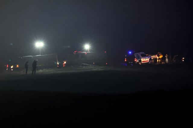 Ambulances and rescue vehicles are stationed at the wreckage site as search and rescue operations are ungoing following the crash of a Libya-bound business jet carrying Libyan Chief of Staff General Muhammad Ali Ahmed Al-Haddad, found 2 kilometers south of Kesikkavak Village at Haymana district in Ankara on December 23, 2025. The head of Libya's armed forces and four other passengers died on December 23, 2025, when their business jet crashed shortly after taking off from Ankara, officials in Turkey's capital and Tripoli said. The wreckage of their Falcon 50 aircraft was located by Turkish security personnel in the Haymana district near Ankara, Turkey's Interior Minister said. (Photo by Adem ALTAN / AFP)