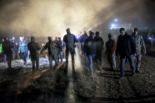 Turkish soldiers evacuate journalists and bystanders from the wreckage site as search and rescue operations are ungoing following the crash of a Libya-bound business jet carrying Libyan Chief of Staff General Muhammad Ali Ahmed Al-Haddad, found 2 kilometers south of Kesikkavak Village at Haymana district in Ankara on December 23, 2025. The head of Libya's armed forces and four other passengers died on December 23, 2025, when their business jet crashed shortly after taking off from Ankara, officials in Turkey's capital and Tripoli said. The wreckage of their Falcon 50 aircraft was located by Turkish security personnel in the Haymana district near Ankara, Turkey's Interior Minister said. (Photo by ADEM ALTAN / AFP)