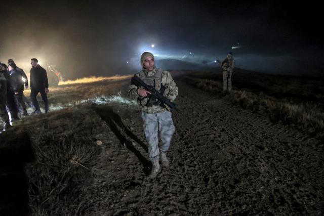Turkish soldiers evacuate journalists and bystanders from the wreckage site as search and rescue operations are ungoing following the crash of a Libya-bound business jet carrying Libyan Chief of Staff General Muhammad Ali Ahmed Al-Haddad, found 2 kilometers south of Kesikkavak Village at Haymana district in Ankara on December 23, 2025. The head of Libya's armed forces and four other passengers died on December 23, 2025, when their business jet crashed shortly after taking off from Ankara, officials in Turkey's capital and Tripoli said. The wreckage of their Falcon 50 aircraft was located by Turkish security personnel in the Haymana district near Ankara, Turkey's Interior Minister said. (Photo by ADEM ALTAN / AFP)