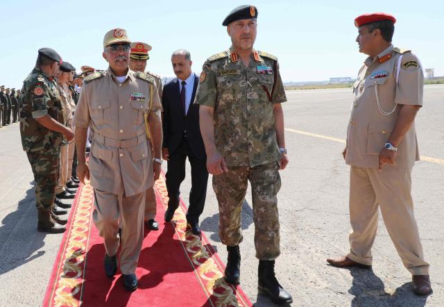 (FILES) Self-proclaimed Libyan National Army's (LNA) Chief of General Staff, Major General Abdel Razek al-Nazuri (L), is welcomed by Lieutenant General Mohammad Ali al-Haddad (C), chief of the general staff of the Libyan army upon his arrival at the Mitiga International Airport on July 18, 2022. The head of Libya's armed forces General Muhammad Ali al-Haddad and four other passengers died on December 23, 2025, when their business jet crashed shortly after taking off from Ankara, officials in Turkey's capital and Tripoli said. The wreckage of their Falcon 50 aircraft was located by Turkish security personnel in the Haymana district near Ankara, Turkey's Interior Minister said. (Photo by AFP)