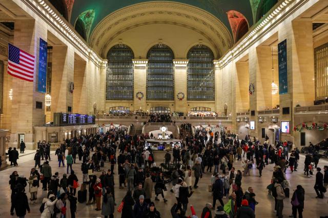 People makes their way through Grand Central Station on December 23, 2025 in New York. (Photo by ANGELA WEISS / AFP)