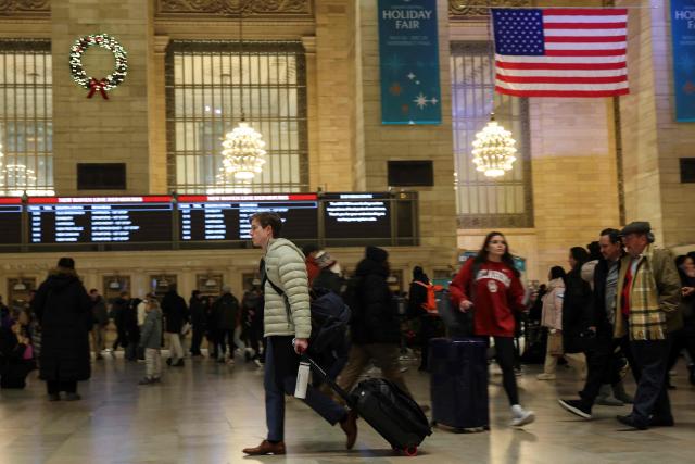 People make their way through Grand Central Station on December 23, 2025 in New York. (Photo by ANGELA WEISS / AFP)