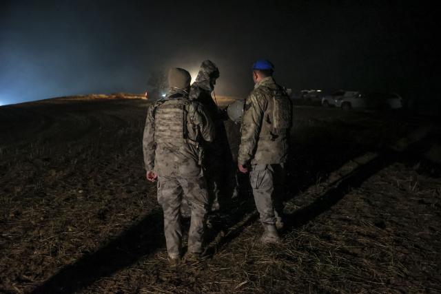Turkish soldiers stand guard at the wreckage site of a Libya-bound business jet as search and rescue operations continue following the crash of a Falcon 50 aircraft carrying Libyan Chief of Staff General Muhammad Ali Ahmed Al-Haddad, found 2 kilometers south of Kesikkavak Village at Haymana district in Ankara on December 23, 2025. The head of Libya's armed forces and four other passengers died on December 23 when their business jet crashed shortly after taking off from Ankara, officials in Turkey's capital and Tripoli said.
The wreckage of their Falcon 50 aircraft was located by Turkish security personnel in the Haymana district near Ankara, Turkish Interior Minister Ali Yerlikaya said. (Photo by ADEM ALTAN / AFP)