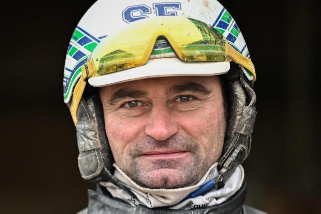 Horse Josh Power's French driver and trainer Sebastien Ernault poses after a training session at the Le Long Bois in Saint-Come-du-Mont, northwestern France on December 23, 2025. Horse Josh Power has qualified, and is one of the favorites, for the 105th edition of the Prix d'Amerique, which will be held at the Paris-Vincennes racecourse on January 25, 2026. (Photo by LOU BENOIST / AFP)