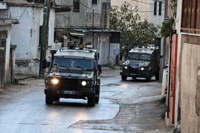 Israeli security forces leave the Palestinian village of Bizariya, in the occupied West Bank, where Israeli authorities demolished the house of a Palestinian man killed in July after he and another man reportedly killed an Israeli settler on the same day, on December 24, 2025. (Photo by Zain JAAFAR / AFP)