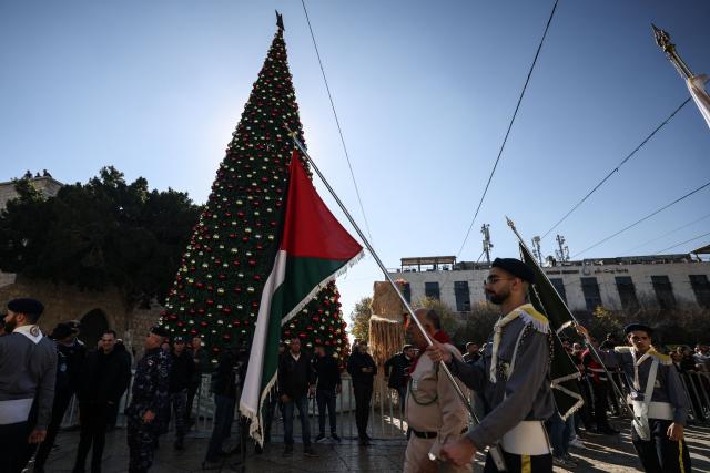 Members of the scouting movement march during Christmas eve celebrations at the Manger Square outside the Church of the Nativity in Bethlehem, in the Israeli-occupied West Bank, on December 24, 2025. (Photo by HAZEM BADER / AFP)