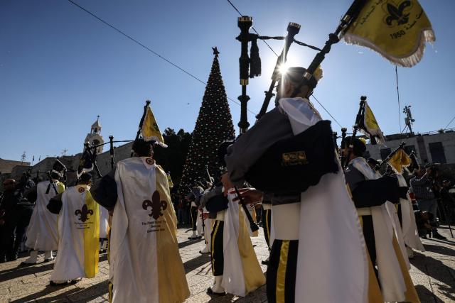 Members of the scouting movement march during Christmas eve celebrations at the Manger Square outside the Church of the Nativity in Bethlehem, in the Israeli-occupied West Bank, on December 24, 2025. (Photo by HAZEM BADER / AFP)