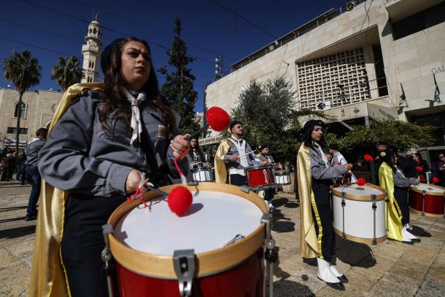 Members of the scouting movement march during Christmas eve celebrations at the Manger Square outside the Church of the Nativity in Bethlehem, in the Israeli-occupied West Bank, on December 24, 2025. (Photo by HAZEM BADER / AFP)