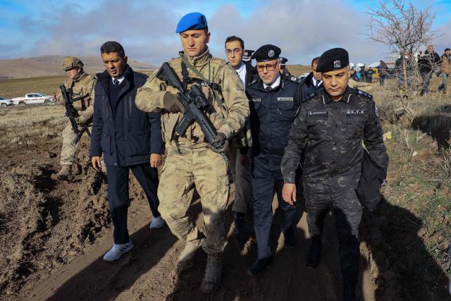 Libyan military delegation members arrive at the wreckage site following the crash of a Libya-bound business jet carrying Libyan Chief of Staff General Muhammad Ali Ahmed Al-Haddad, found 2 kilometers south of Kesikkavak Village at Haymana district in Ankara on December 24, 2025. The head of Libya's armed forces and four other passengers died on Tuesday when their business jet crashed shortly after taking off from Ankara, officials in Turkey's capital and Tripoli said. The wreckage of their Falcon 50 aircraft was located by Turkish security personnel in the Haymana district near Ankara, Turkey's Interior Minister said. (Photo by ADEM ALTAN / AFP)