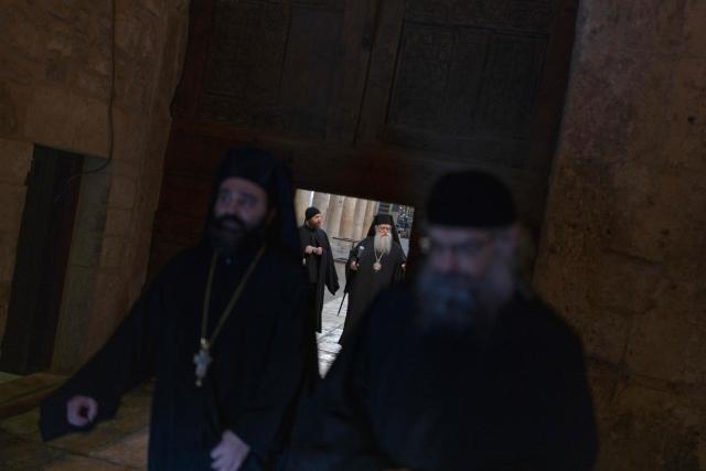 Orthodox Christian priests arrive in the Church of the Nativity, ahead of the arrival of Latin Patriarch of Jerusalem to celebrate Christmas Mass, in the biblical city of Bethlehem in the Israeli-occupied West Bank on Christmas eve on December 24, 2025. Scouts marched under a clear blue sky in Bethlehem on December 24, 2025, as the Palestinian city emerged from the shadow of the war in Gaza to celebrate its first festive Christmas in more than two years. Throughout the Gaza war that began with Hamas's attack on Israel in October 2023, a sombre tone marked Chistmases in Bethlehem, the biblical birthplace of Jesus Christ. (Photo by ILIA YEFIMOVICH / AFP)