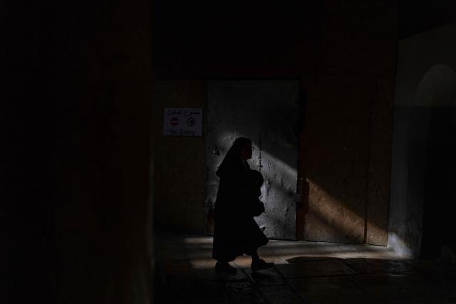 A num walks in the Church of the Nativity, ahead of the arrival of Latin Patriarch of Jerusalem to celebrate Christmas Mass, in the biblical city of Bethlehem in the Israeli-occupied West Bank on Christmas eve on December 24, 2025. Scouts marched under a clear blue sky in Bethlehem on December 24, 2025, as the Palestinian city emerged from the shadow of the war in Gaza to celebrate its first festive Christmas in more than two years. Throughout the Gaza war that began with Hamas's attack on Israel in October 2023, a sombre tone marked Chistmases in Bethlehem, the biblical birthplace of Jesus Christ. (Photo by ILIA YEFIMOVICH / AFP)