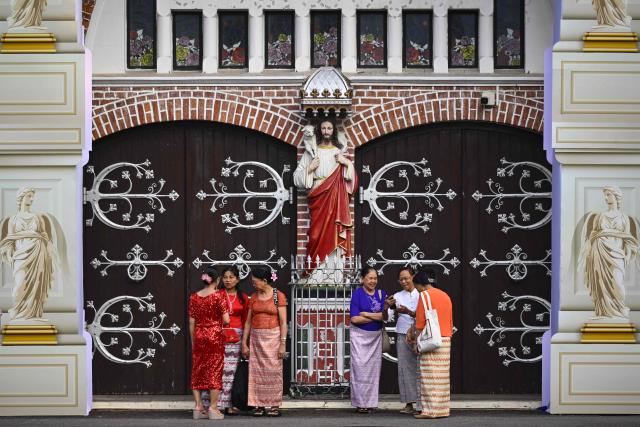 Christian devotees arrive to attend a Christmas Eve mass at the St. Mary’s Cathedral in Yangon on December 24, 2025. (Photo by Sai Aung MAIN / AFP)