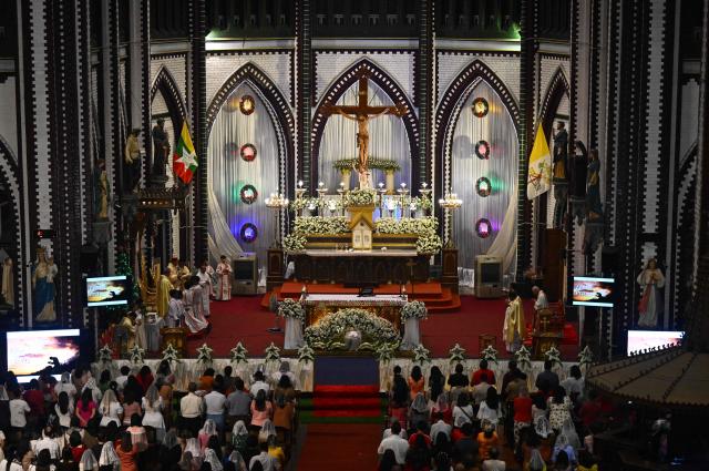 Christian devotees pray during a Christmas Eve mass at the St. Mary’s Cathedral in Yangon on December 24, 2025. (Photo by Sai Aung MAIN / AFP)