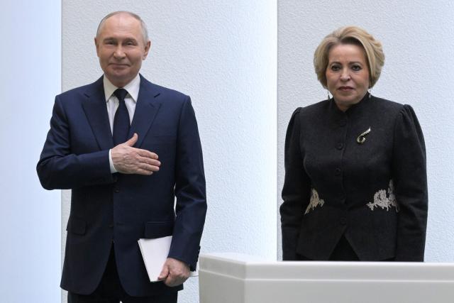 In this pool photograph distributed by the Russian state agency Sputnik, Russia's President Vladimir Putin and Federation Council speaker Valentina Matviyenko attend a session of the Federation Council, the upper house of Russia's parliament, in Moscow on December 24, 2025. (Photo by Alexey NIKOLSKY / POOL / AFP)