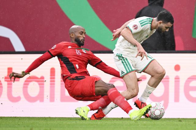 Sudan's midfielder #15 Salaheldin Adil (L) tackles Algeria's defender #15 Rayan Ait-Nouri and is then sent off during the Africa Cup of Nations (CAN) Group E football match between Algeria and Sudan at Moulay Hassan Stadium in Rabat on December 24, 2025. (Photo by SEBASTIEN BOZON / AFP)