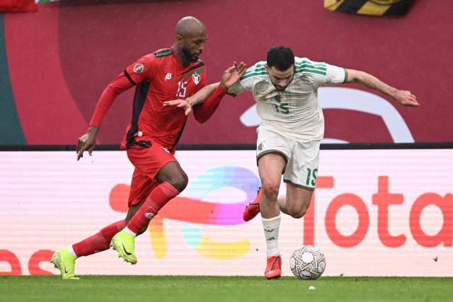 Sudan's midfielder #15 Salaheldin Adil (L) tackles Algeria's defender #15 Rayan Ait-Nouri and is then sent off during the Africa Cup of Nations (CAN) Group E football match between Algeria and Sudan at Moulay Hassan Stadium in Rabat on December 24, 2025. (Photo by SEBASTIEN BOZON / AFP)