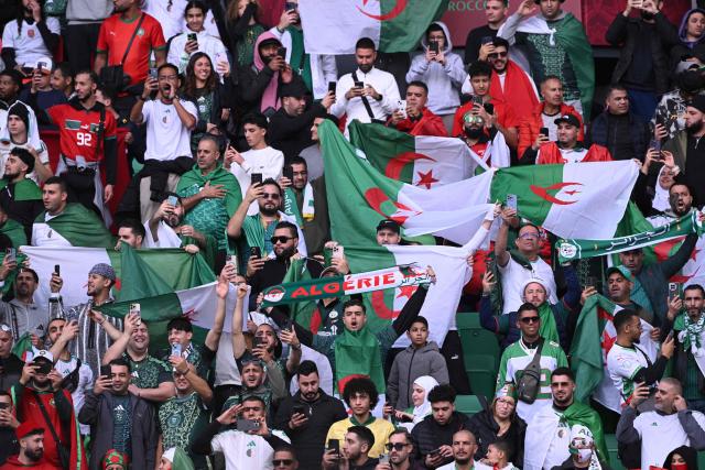 Algeria suppoerters cheer from the stand during the Africa Cup of Nations (CAN) Group E football match between Algeria and Sudan at Moulay Hassan Stadium in Rabat on December 24, 2025. (Photo by SEBASTIEN BOZON / AFP)