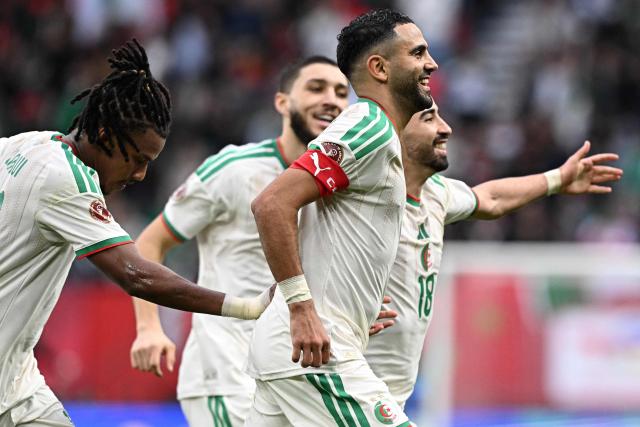 Algeria's forward #7 Riyad Mahrez (R) celebrates scoring the team's second goal during the Africa Cup of Nations (CAN) Group E football match between Algeria and Sudan at Moulay Hassan Stadium in Rabat on December 24, 2025. (Photo by Gabriel BOUYS / AFP)