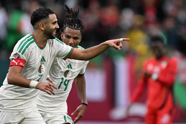 Algeria's forward #7 Riyad Mahrez (L) celebrates scoring the team's second goal during the Africa Cup of Nations (CAN) Group E football match between Algeria and Sudan at Moulay Hassan Stadium in Rabat on December 24, 2025. (Photo by Gabriel BOUYS / AFP)