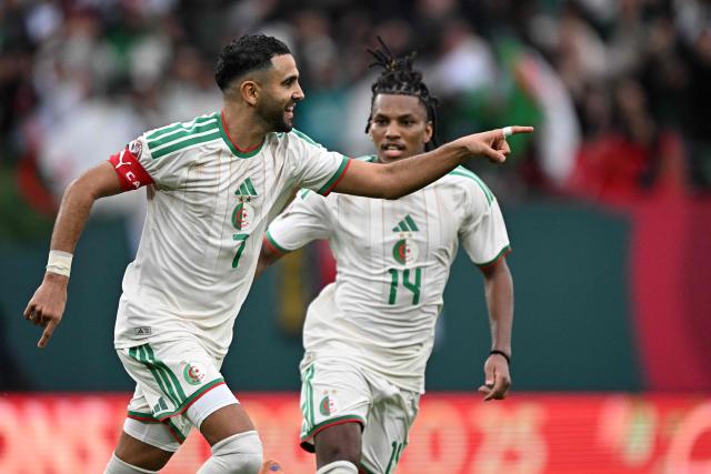 Algeria's forward #7 Riyad Mahrez (L) celebrates with Algeria's midfielder #14 Hicham Boudaoui after scoring the team's second goalduring the Africa Cup of Nations (CAN) Group E football match between Algeria and Sudan at Moulay Hassan Stadium in Rabat on December 24, 2025. (Photo by Gabriel BOUYS / AFP)