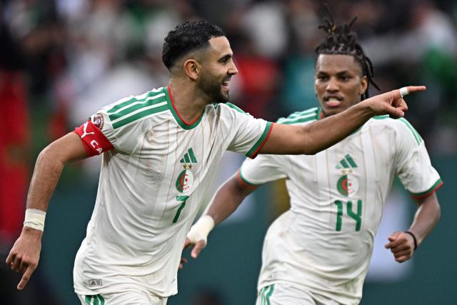 Algeria's forward #7 Riyad Mahrez (L) celebrates celebrates scoring the team's second goal with Algeria's midfielder #14 Hicham Boudaoui during the Africa Cup of Nations (CAN) Group E football match between Algeria and Sudan at Moulay Hassan Stadium in Rabat on December 24, 2025. (Photo by Gabriel BOUYS / AFP)