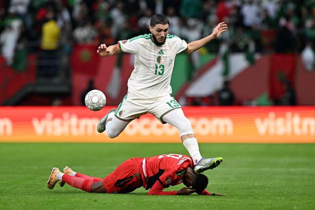 Algeria's defender #13 Jaouen Hadjam connects with the head of Sudan's midfielder #8 Abdelrazig Omer during the Africa Cup of Nations (CAN) Group E football match between Algeria and Sudan at Moulay Hassan Stadium in Rabat on December 24, 2025. (Photo by Gabriel BOUYS / AFP)