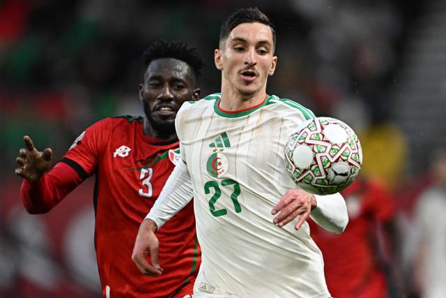 Sudan's defender #3 Mohamed Saeed Ahmed (L) closes in on Algeria's forward #27 Adil Boulbina during the Africa Cup of Nations (CAN) Group E football match between Algeria and Sudan at Moulay Hassan Stadium in Rabat on December 24, 2025. (Photo by Gabriel BOUYS / AFP)